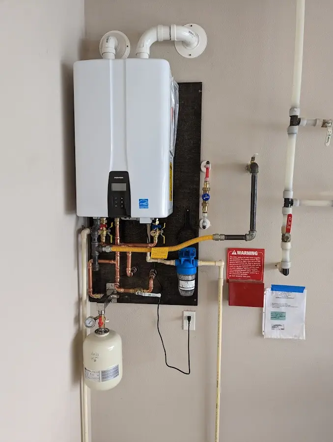 Professional plumber installing copper piping in a Kings Grant home